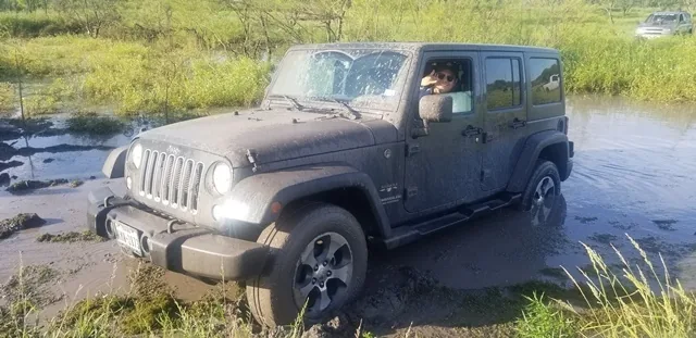Jeep Wrangler in mud pit at 281 Country Club offroad park San Antonio